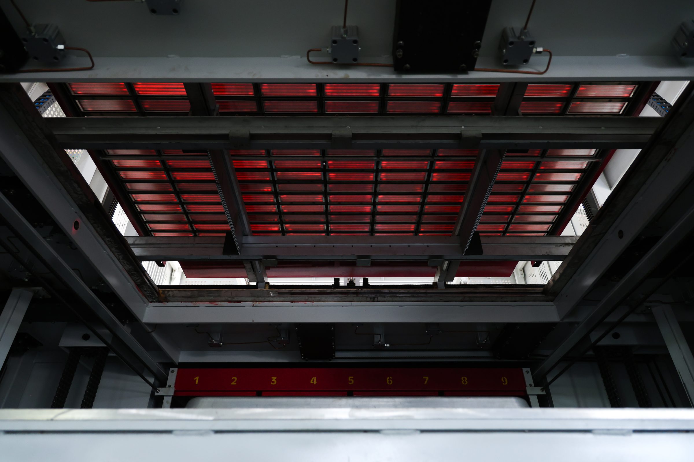 Interior view of a PF1 forming area with a heater bank and numbered machine frame.