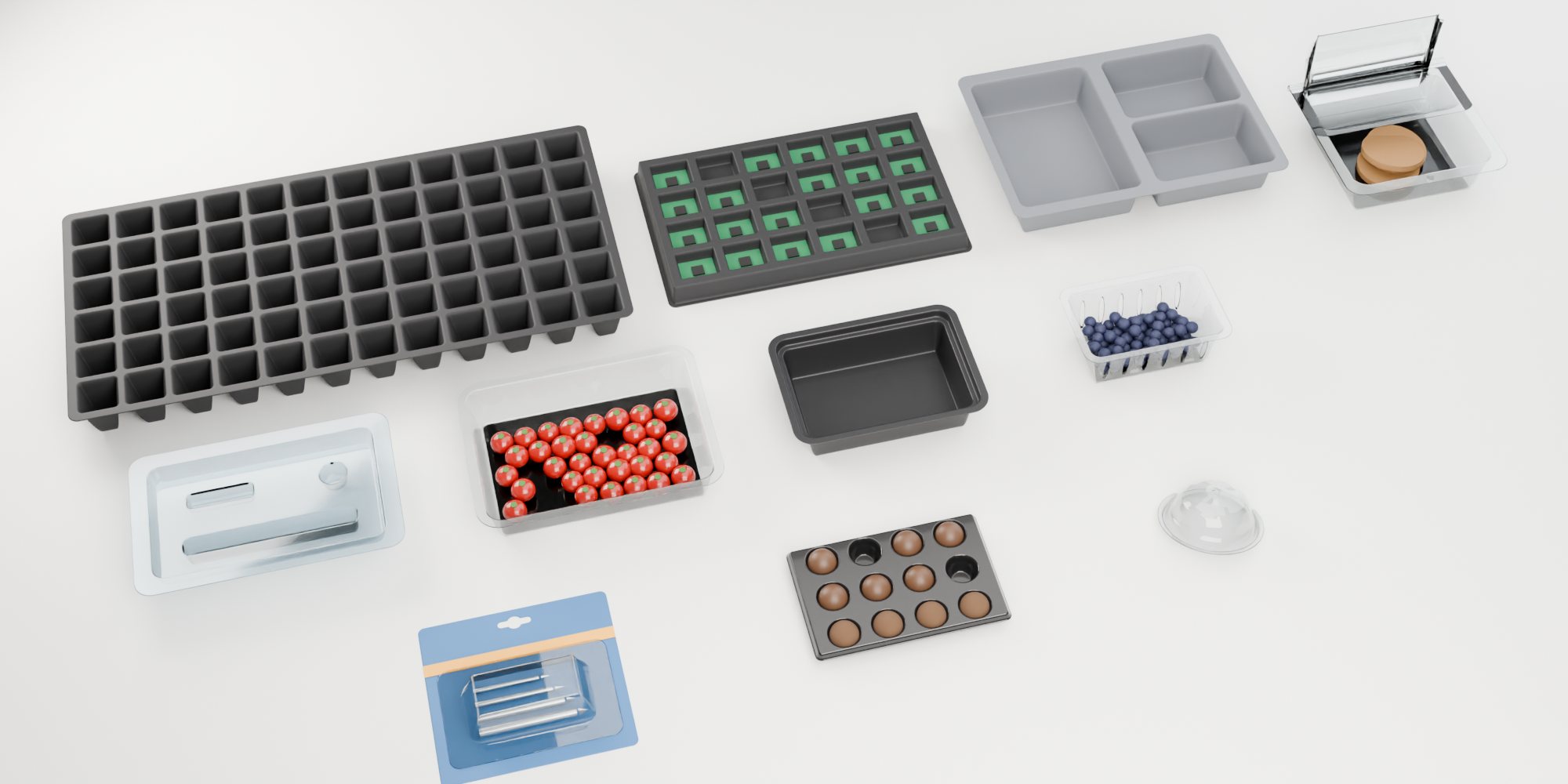 Eleven thin-gauge parts made on AM-X machines, from cup lids and punnets to an electronics tray and a nursery tray